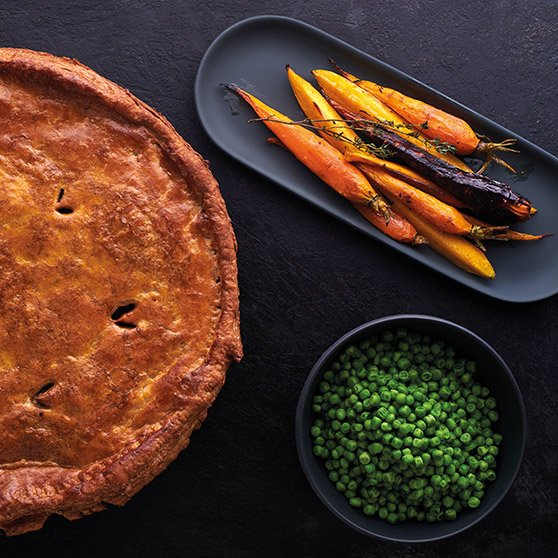 Golden-brown pie, colorful roasted carrots, and green peas – professionally prepared using HOBART's CHEF'S COMBI for perfect browning and even cooking results.