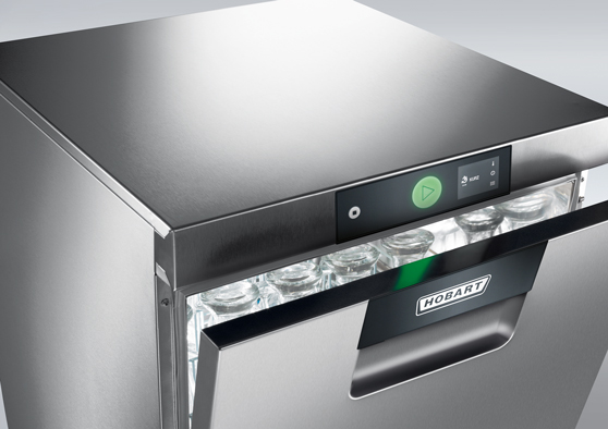 HOBART undercounter dishwasher in stainless steel with partially open door showing glasses inside, featuring a digital control panel and green start button.
