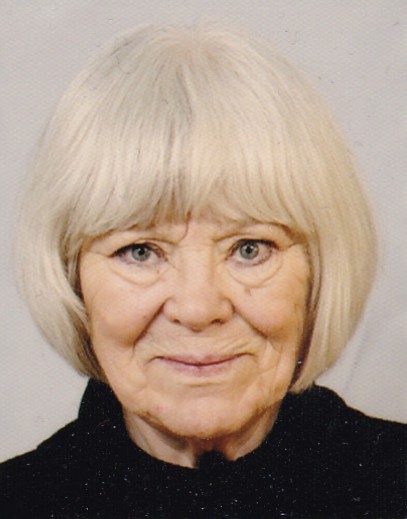 Portrait of artist Monika Johannisson against a light background, wearing a dark top and with chin‑length light‑blonde hair. The calm composition reflects her artistic approach, characterized by acrylics, ink, charcoal and detailed, long‑developed works.